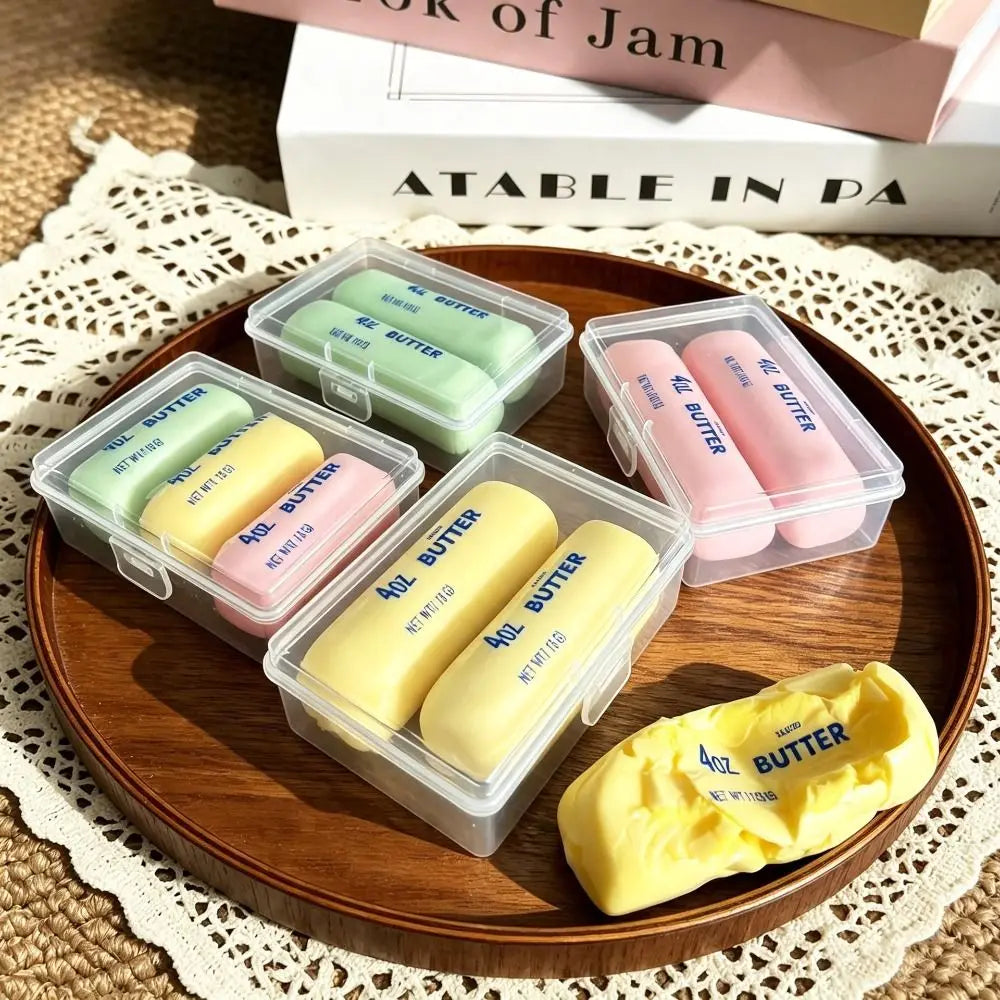 Clear box with three mini crunchy butter stick squishies in green, pink, and yellow.